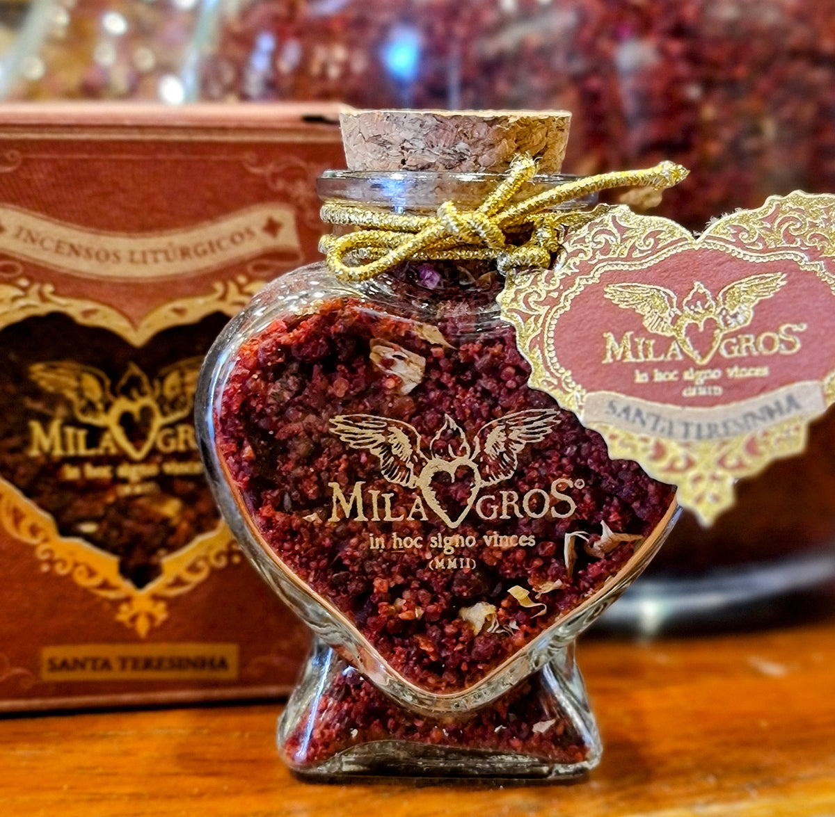 Close-up of the heart-shaped Cuore glass jar of Milagros Saint Therese of Lisieux resin incense with cork stopper and heart hangtag.