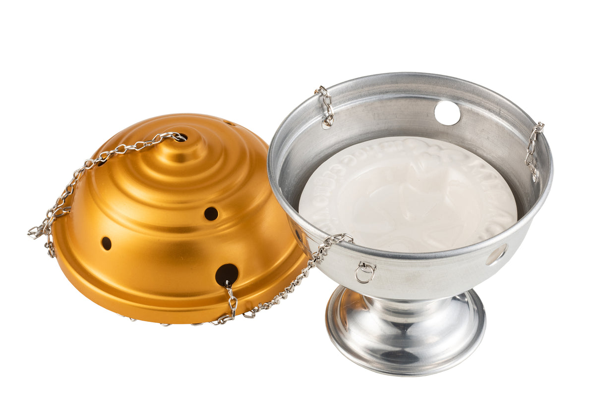 Matte gold thurible shown open, with vented lid and white ceramic liner in the bowl