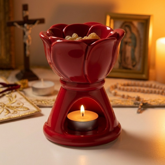 Tea light inside a ceramic resin incense burner with frankincense tears warming on the ceramic above