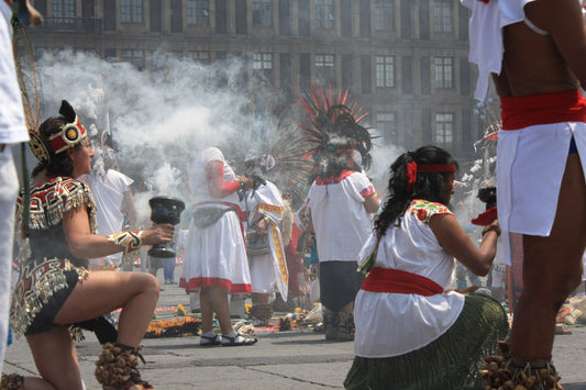 Dancers in Mexico City burning copal in clay sahumadores, with thick white smoke rising