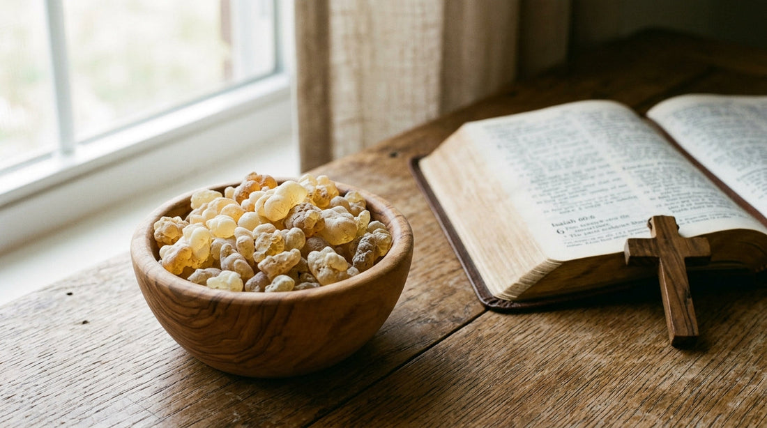 Golden frankincense resin tears in a wooden bowl beside an open Bible page, soft natural light.
