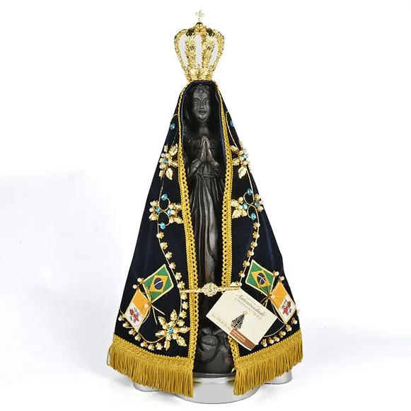 Statue of a religious figure with a black face, draped in a black cloth with gold trim and a crown, on a white background.